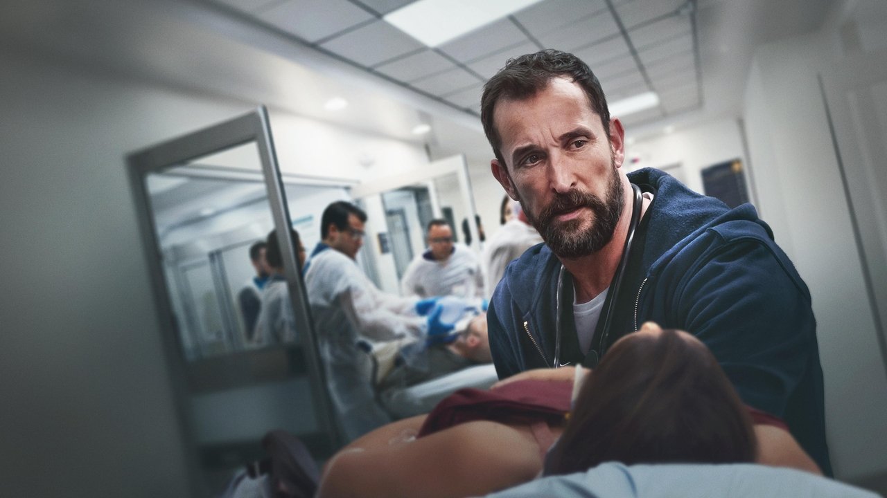 Dr. Robby leaning over a patient in a trauma bay